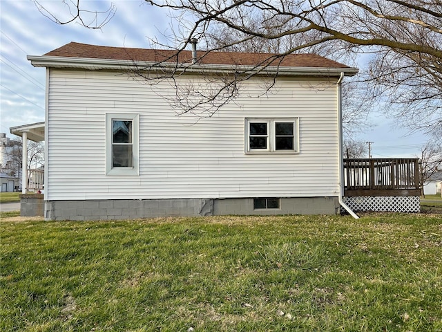 view of home's exterior featuring a lawn and a wooden deck