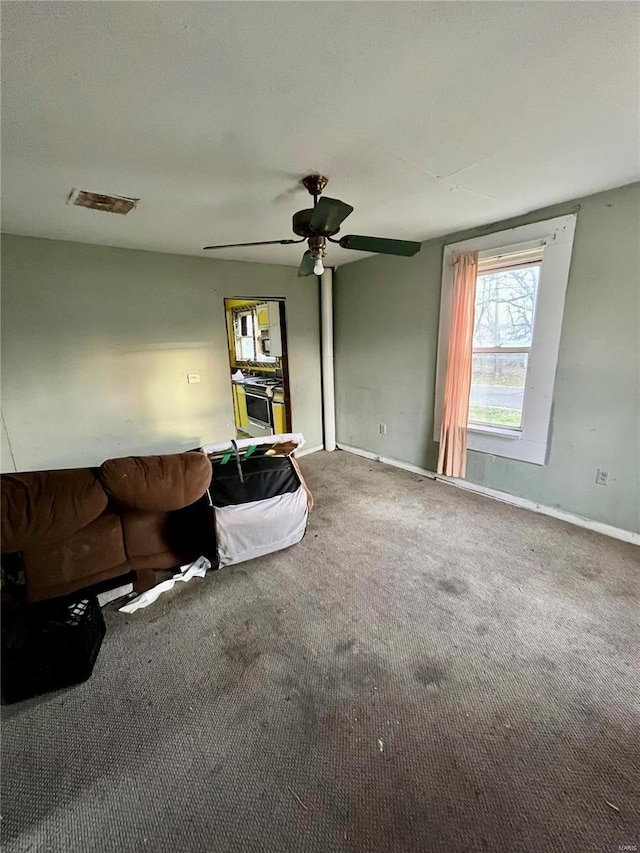 unfurnished living room featuring ceiling fan and carpet floors