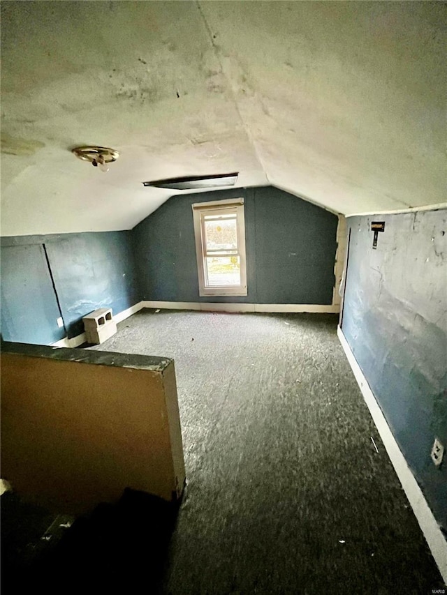 bonus room featuring a textured ceiling and lofted ceiling