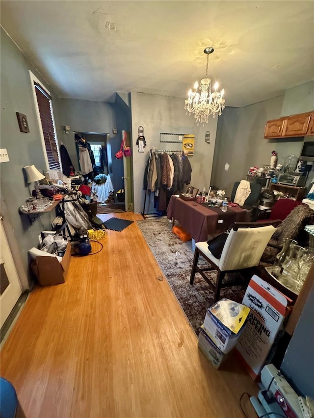 miscellaneous room featuring light hardwood / wood-style floors and an inviting chandelier