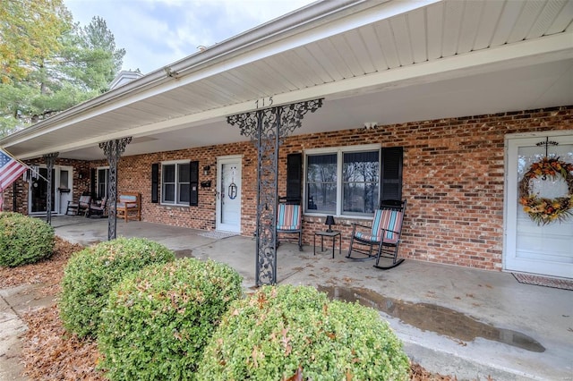 view of exterior entry featuring a porch