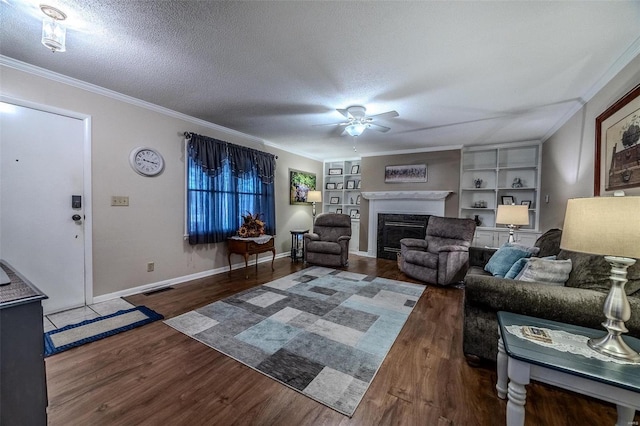 living room featuring built in shelves, ceiling fan, a textured ceiling, and a high end fireplace