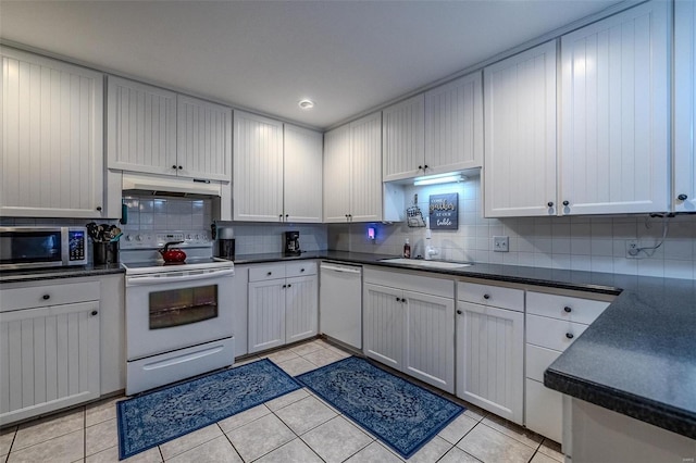 kitchen with white cabinetry, sink, light tile patterned floors, and white appliances