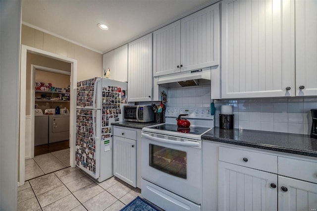 kitchen with white appliances, white cabinets, crown molding, decorative backsplash, and washing machine and dryer