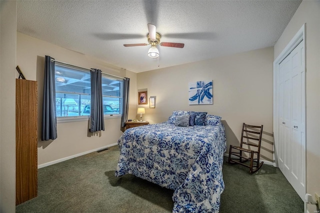 carpeted bedroom with a textured ceiling, a closet, and ceiling fan