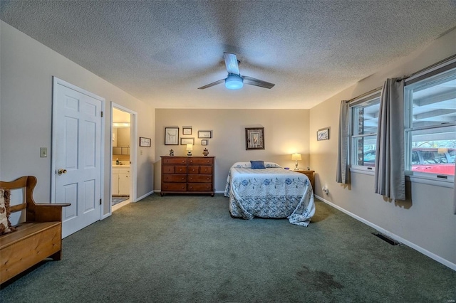 carpeted bedroom featuring ceiling fan and a textured ceiling