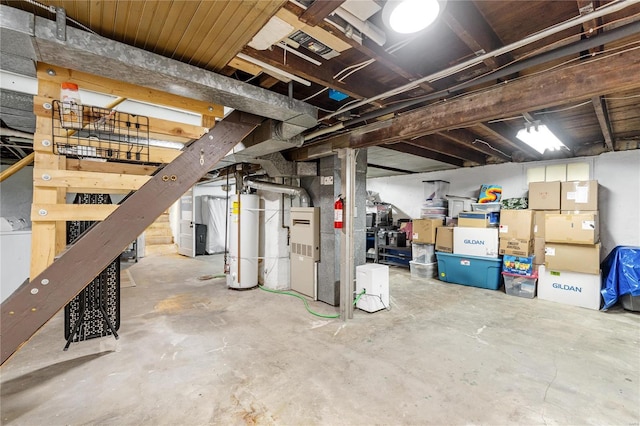 basement featuring heating unit and water heater