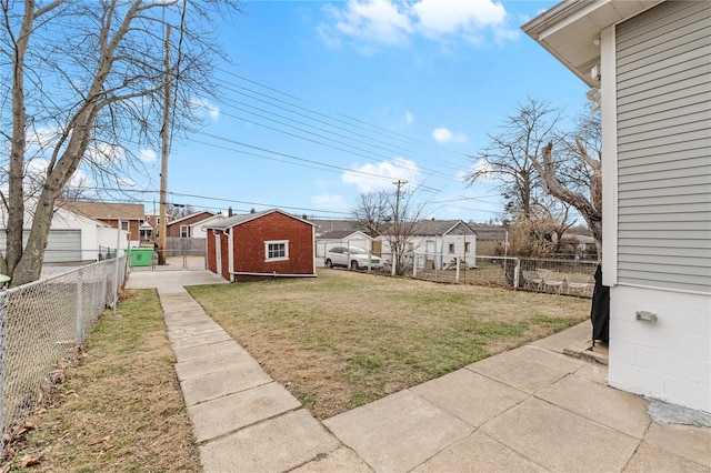 view of yard featuring a shed and a patio