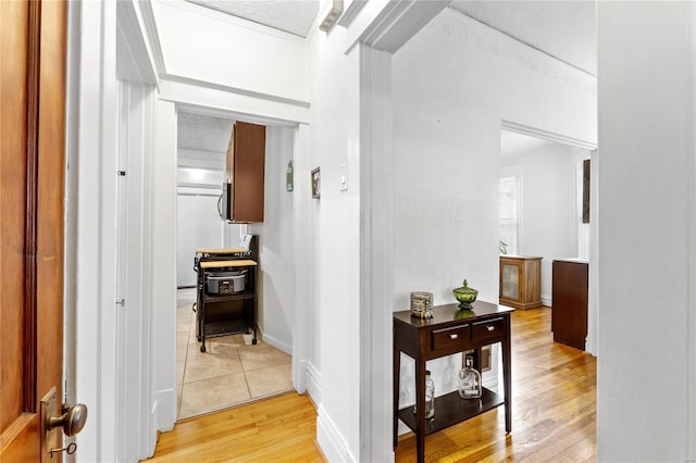 hallway featuring a textured ceiling and light wood-type flooring