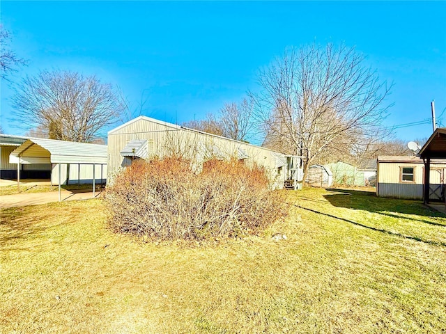 view of home's exterior featuring a lawn and a carport