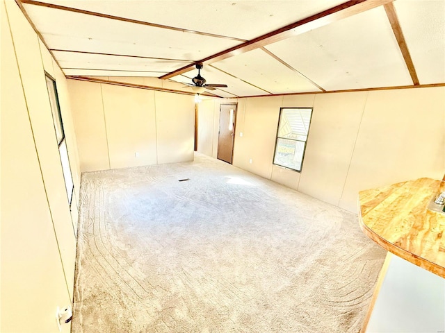 basement with carpet floors and ceiling fan