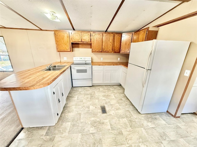 kitchen with kitchen peninsula, a textured ceiling, white appliances, sink, and white cabinetry