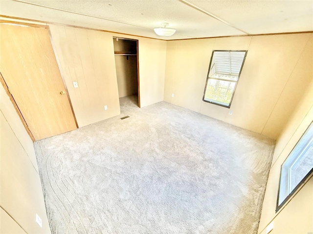 unfurnished bedroom with carpet flooring, a closet, and a textured ceiling