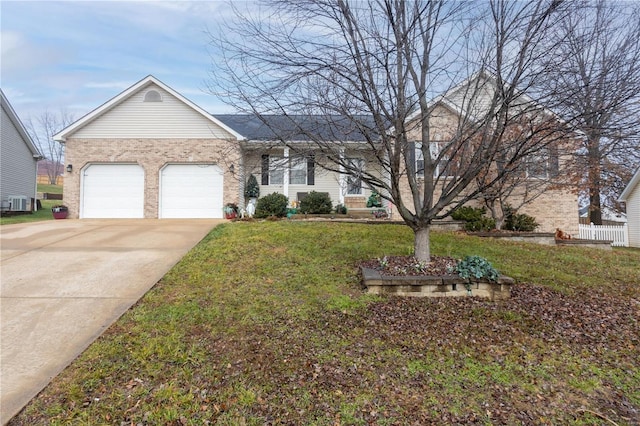 ranch-style house featuring a garage, central air condition unit, and a front yard