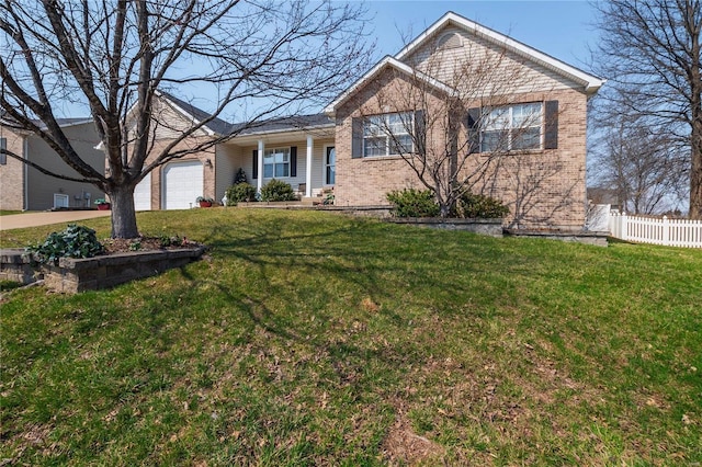 ranch-style home with brick siding, a front lawn, fence, and a garage