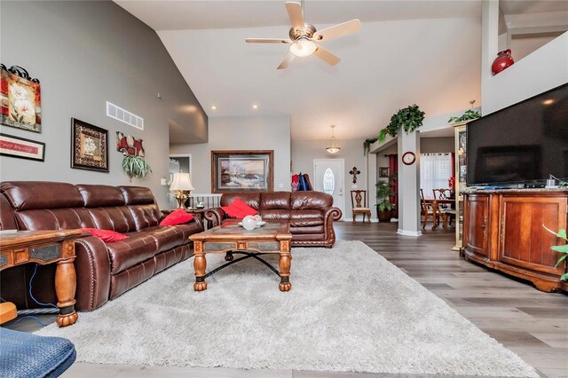 living room with visible vents, high vaulted ceiling, a ceiling fan, and wood finished floors