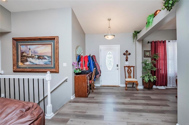 entryway with baseboards and wood finished floors