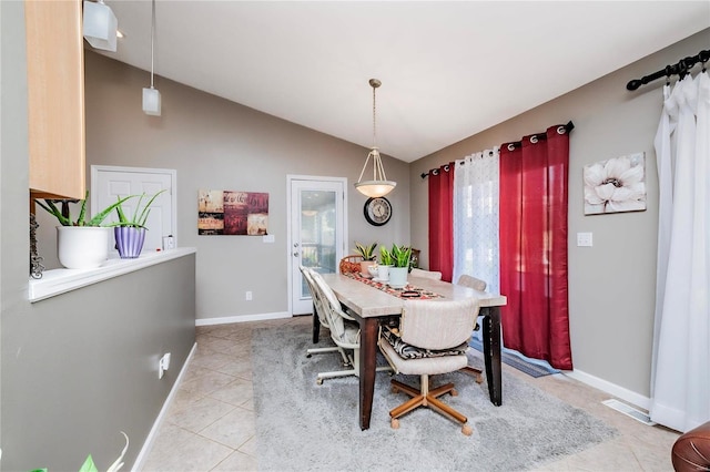 dining space with lofted ceiling, light tile patterned floors, baseboards, and visible vents