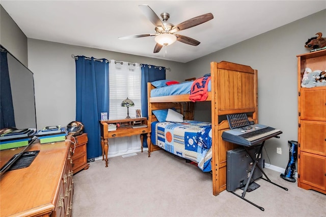 bedroom with baseboards, light carpet, and a ceiling fan