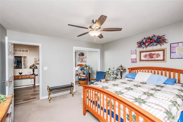 bedroom with a ceiling fan, baseboards, visible vents, a closet, and light carpet