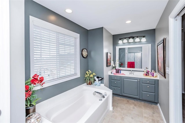 full bath with vanity, recessed lighting, tile patterned flooring, walk in shower, and a garden tub