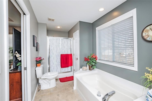 bathroom with visible vents, toilet, a stall shower, and a bath