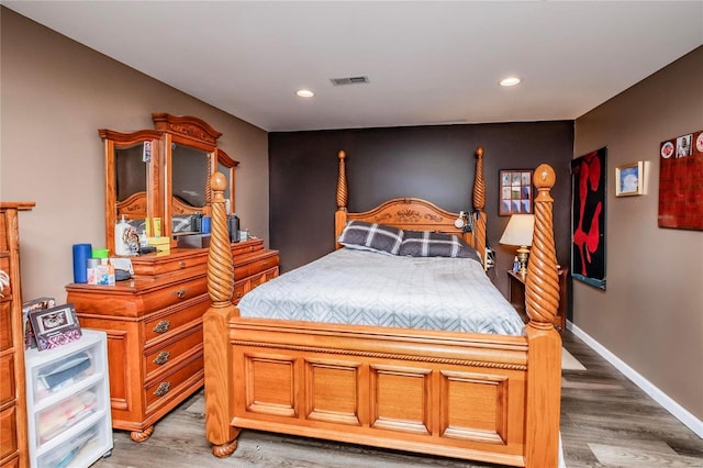 bedroom with visible vents, recessed lighting, baseboards, and wood finished floors