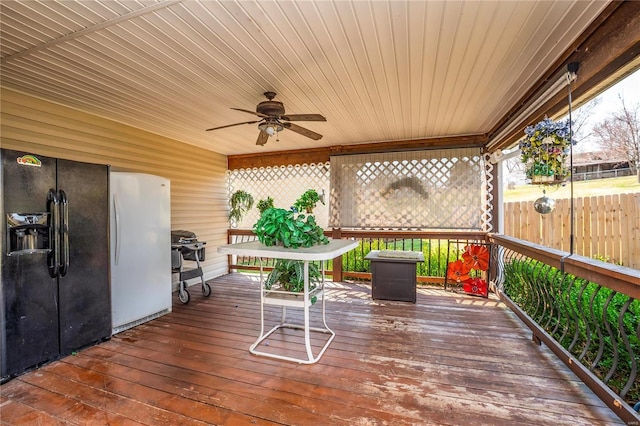 deck featuring ceiling fan and fence