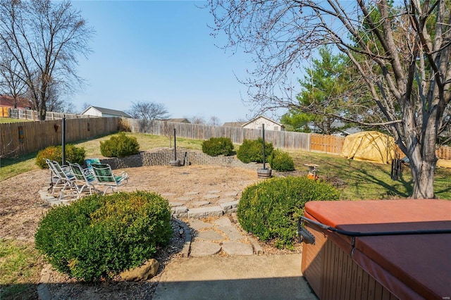 view of yard with a patio area, a hot tub, and a fenced backyard