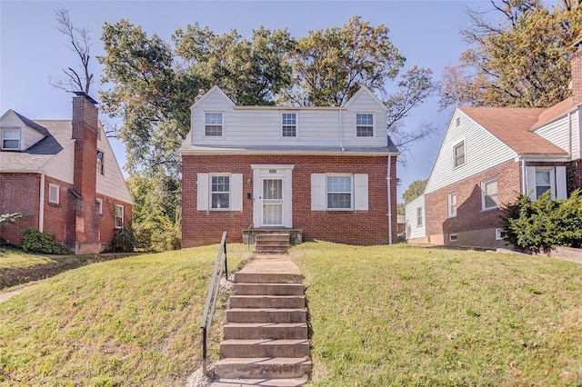 cape cod-style house with brick siding and a front lawn