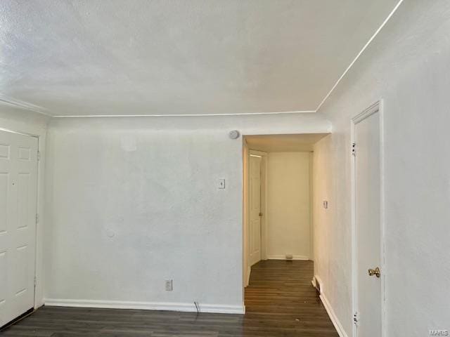 unfurnished room with dark hardwood / wood-style flooring