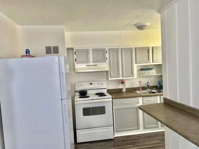 kitchen featuring white appliances, ventilation hood, sink, white cabinets, and dark hardwood / wood-style floors