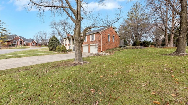 view of side of home featuring a garage and a lawn