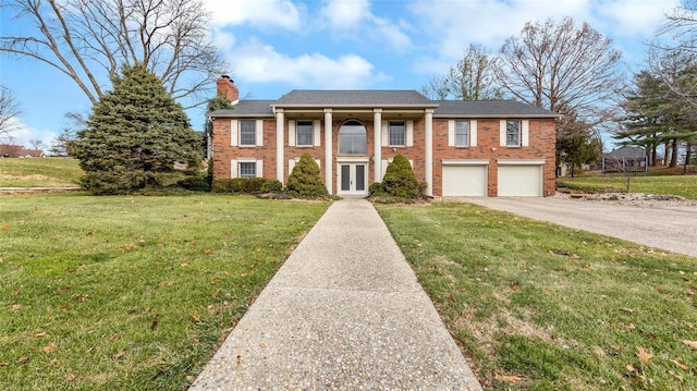 view of front of property featuring a front yard, french doors, and a garage