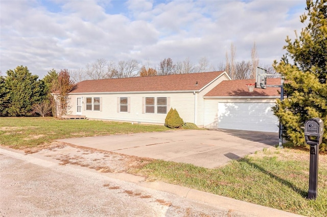 view of front of property with a front yard and a garage