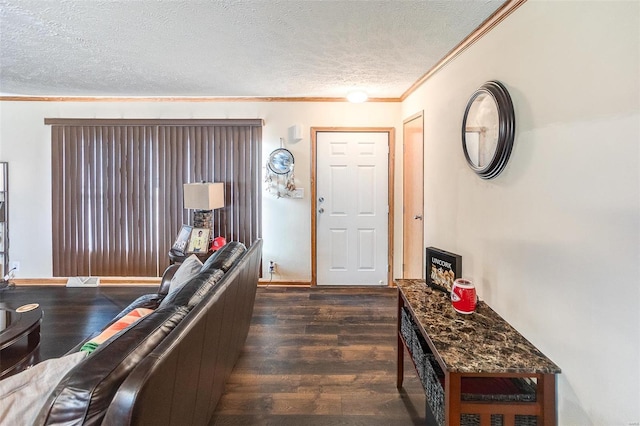 entryway with a textured ceiling, dark hardwood / wood-style floors, and ornamental molding