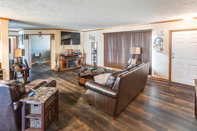 living room with a textured ceiling, crown molding, and dark wood-type flooring