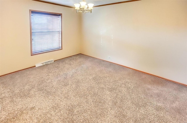 carpeted spare room with crown molding and a notable chandelier