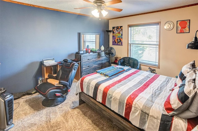 carpeted bedroom with ceiling fan, a textured ceiling, and ornamental molding