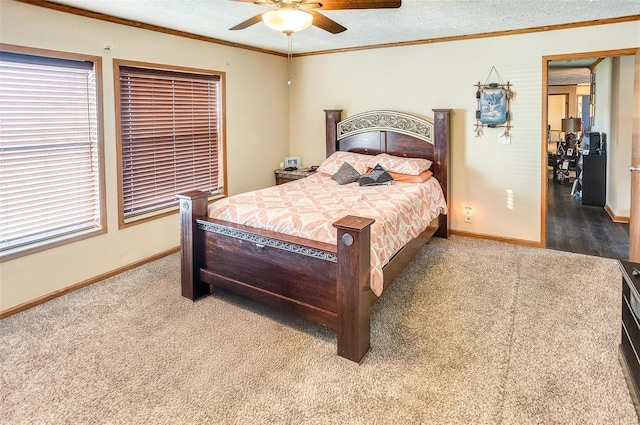 bedroom with ceiling fan, carpet floors, and ornamental molding