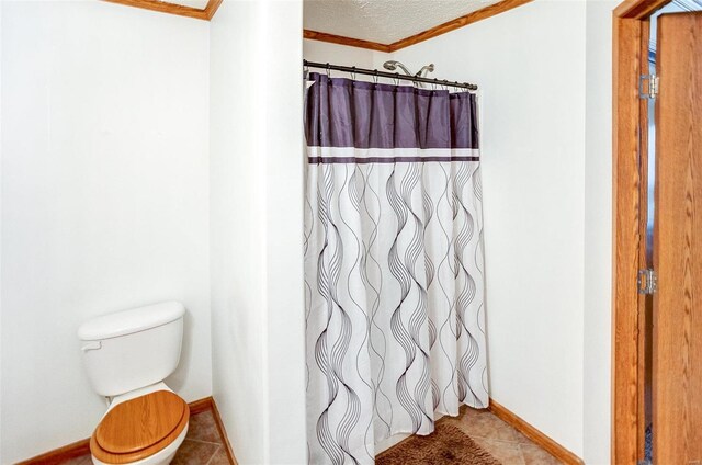 bathroom with tile patterned flooring, toilet, and ornamental molding