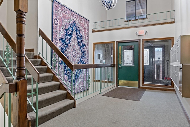 entrance foyer with carpet and a high ceiling