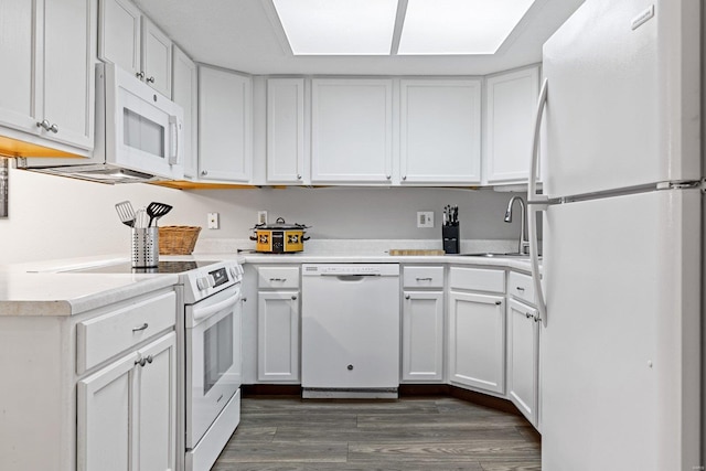 kitchen featuring sink, white cabinets, dark wood-type flooring, and white appliances