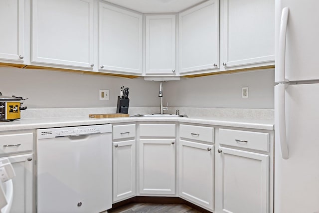 kitchen featuring white cabinets, white appliances, dark hardwood / wood-style floors, and sink