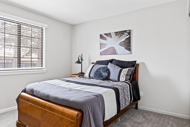 carpeted bedroom featuring a textured ceiling