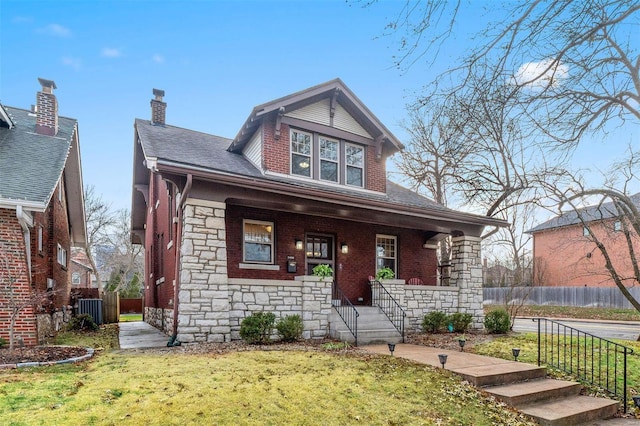 view of front of property featuring central AC unit, a porch, and a front yard