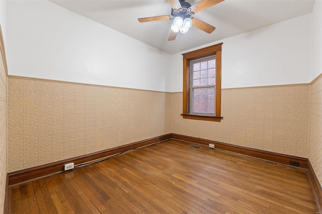 unfurnished room featuring hardwood / wood-style flooring and ceiling fan