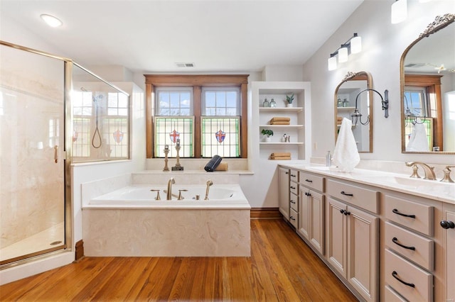 bathroom featuring hardwood / wood-style floors, vanity, and shower with separate bathtub