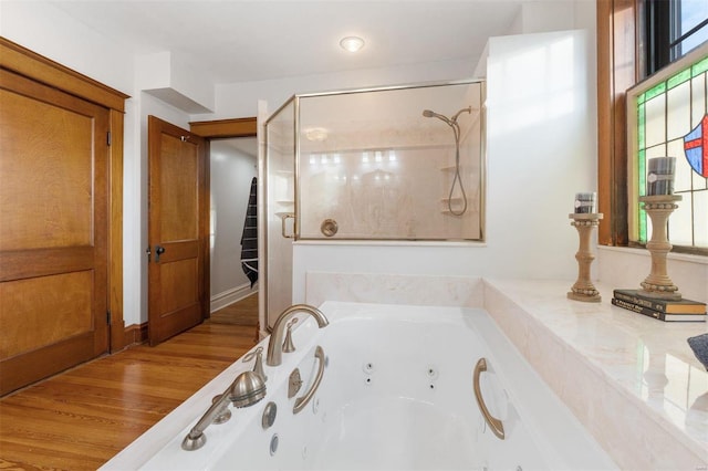 bathroom with plus walk in shower and hardwood / wood-style floors