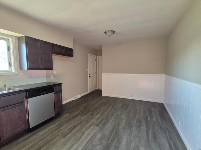 kitchen with stainless steel dishwasher, dark hardwood / wood-style flooring, dark brown cabinetry, and sink